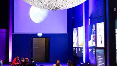 People picnicking under the moon during scienceworks after dark.