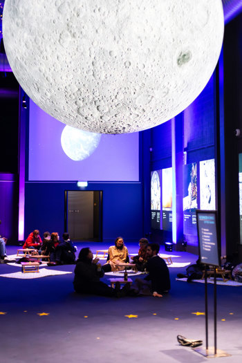 People picnicking under the moon during scienceworks after dark.