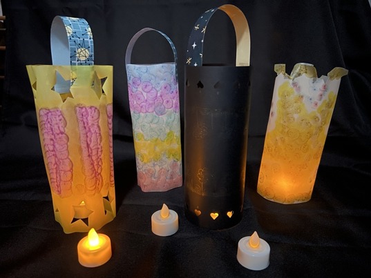 Homemade paper lanterns lit up by fake candle lights. 