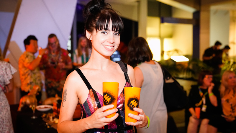 A woman carrying drinks at Nocturnal, Melbourne Museum.