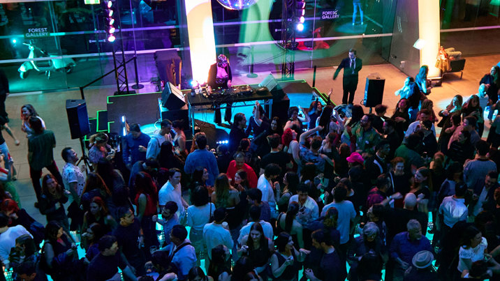 People dancing before a DJ during Discoteca Italiana, Melbourne Museum.