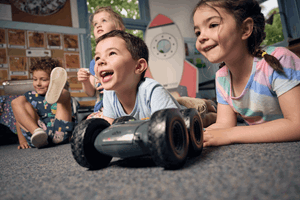 Kindergarten children explore and code rover robots on an imaginary mission to Mars, programming robots around obstacles as they discover how robots can be programmed during Museum Victoria's Rockets and Robots kindergarten incursion program.