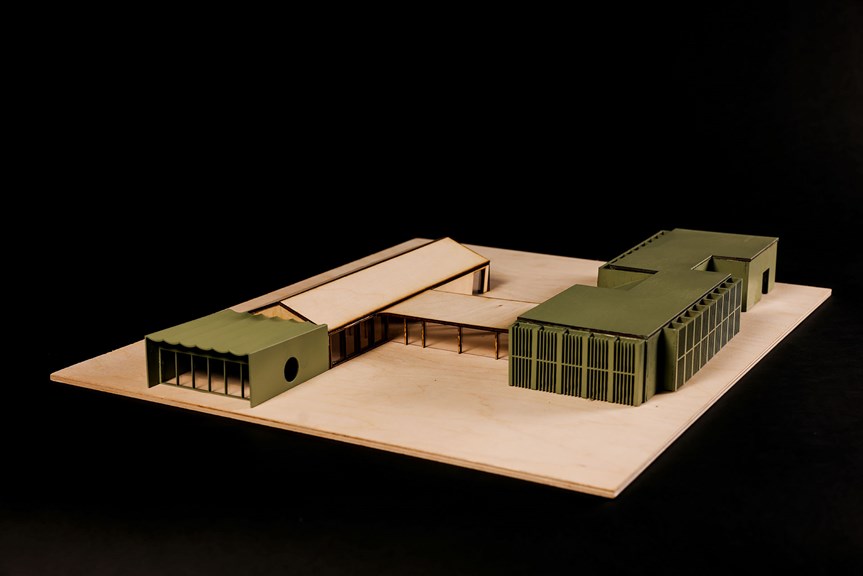 Architectural model of two connected, single storey buildings comprising natural wood and khaki paint.