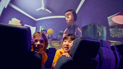 Two primary school students learning about how tilt of the Earth impacts our seasons by viewing Tilt in the Melbourne Planetarium 