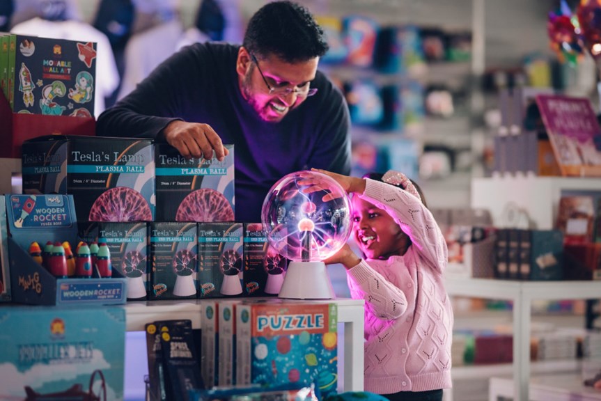 Man and a child looking at merchandise in the Scienceworks shop