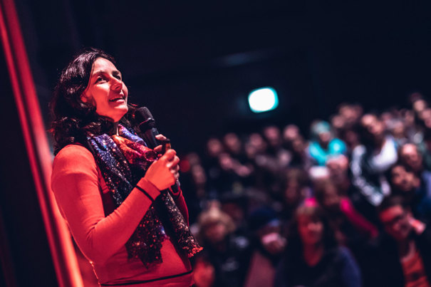 Astronomer Dr Tanya Hill speaking to a crowd in the Melbourne Planetarium. 