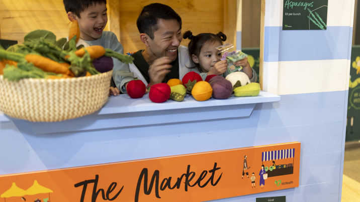 A family learning about where food comes from at the Secret World of food display at Scienceworks.