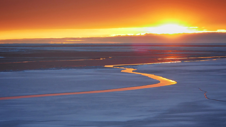 Sunset reflected in sea ice crack, near Casey Station, Antarctica