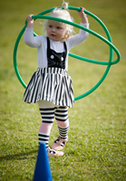 Child playing with hoops during 'Movers and Shakers' Little Kid's Day In.