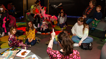 Families enjoying the Hobson's Bay Library Story Time in the Beyond Perception exhibition, during Little Kids Day In - Caring for Country