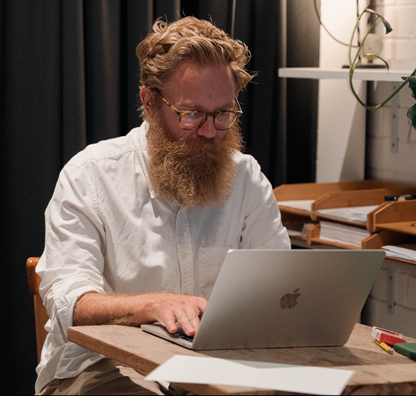 Jackson Wood, wearing glasses, types on a laptop