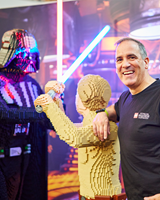 LEGO® Certified Professional Ryan ‘Brickman’ McNaught stands with his creation of Luke Skywalker fighting Darth Vadar at Lego Star Wars Exhibition.