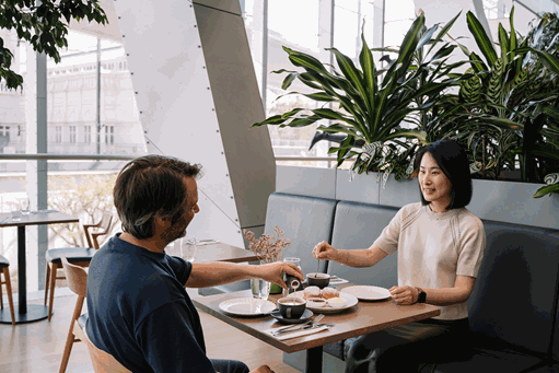 A couple enjoying their Devonshire Tea as part of the Royal Exhibition Building Tour and Devonshire Tea special at Mercury Restaurant, Melbourne Museum.