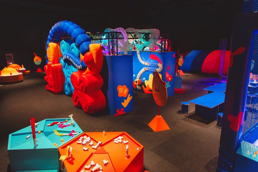 A wide shot of several colourful exhibition interactives.