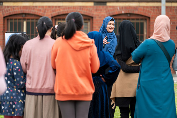 Presenter and participants doing 'cloud' activities outside as part of the workshop.
