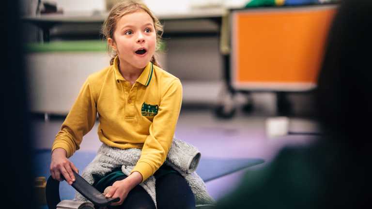 A child having fun while making a toy rollercoaster from everyday materials in education program at Scienceworks.