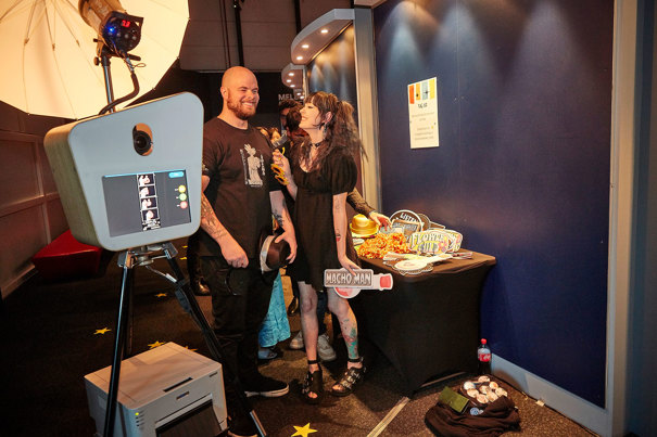 People posing at a photo booth.