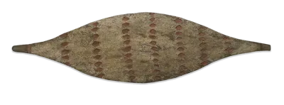 Elongated woven shield decorated with repeating geometric patterns and bands of reddish-brown detailing.
