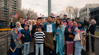 People waving Malaysian flags