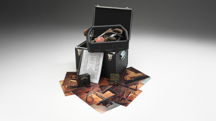 Box of hand tools with supporting pictures used in outreach programs 