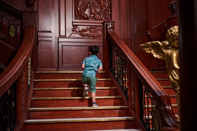  A small boy walking up the Grand Staircase in Titanic: The Artefact Exhibition