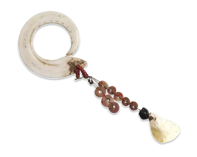 Circular white shell ornament with hanging strands of red shell discs and a shell pendant.