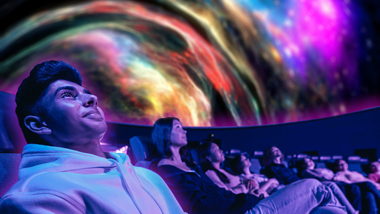 A man looks up at the planetarium ceiling during a Planetarium Night's show.
