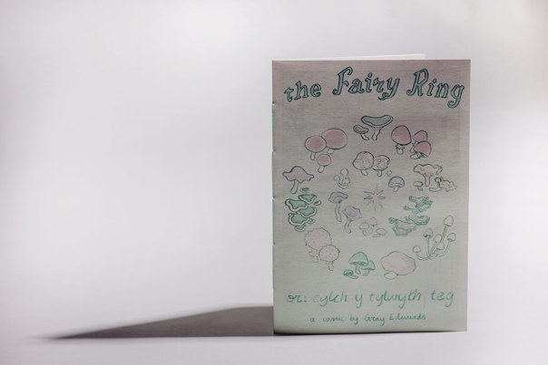 Book cover featuring pencil illustrations of a variety of mushrooms in soft pink, purple, and green tones, arranged in a circular pattern.