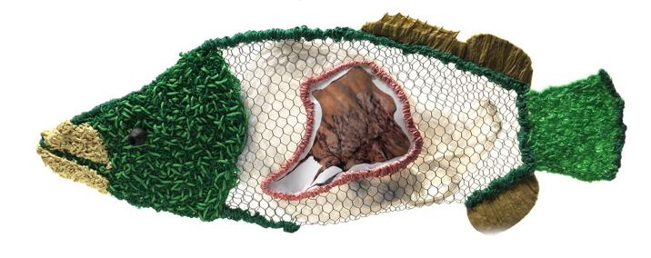 Fish-shaped artwork made from woven fibre, mesh and natural materials.