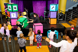  Families engaging with the Robo-Boogie activity in the Amphitheatre during Little Kids Day In program at Scienceworks