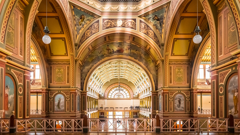 Light streams through the windows beneath the dome of the Royal Exhibition Building ceiling, replete with frescoes and renaissance mural paintings