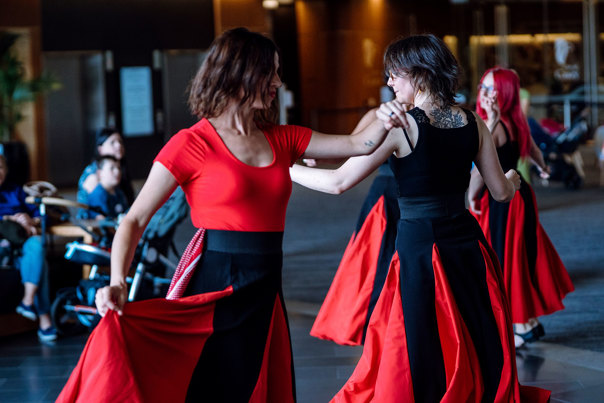 Southern Italian women dancing in red and black dresses