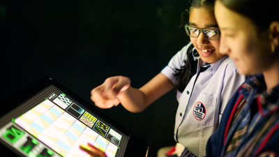 Secondary school students engage with an interactive exhibit within the  Beyond Perception exhibition.