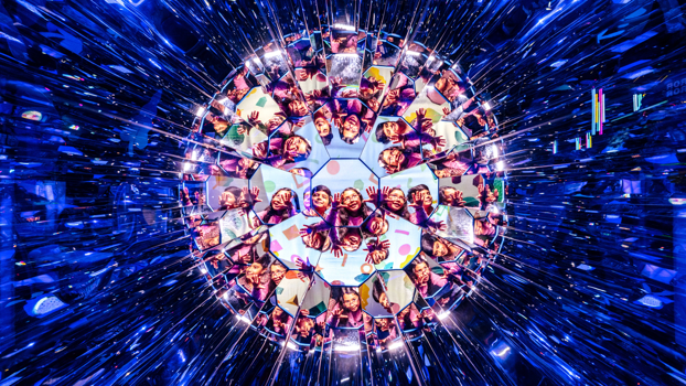 A mirror ball made of images of children smiling.