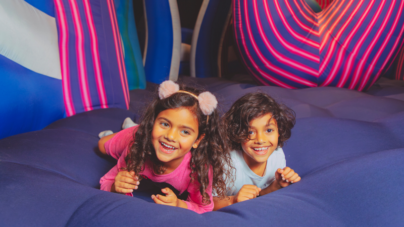 two children lying in the giant tentacular inflatable structure, 'Squish'.