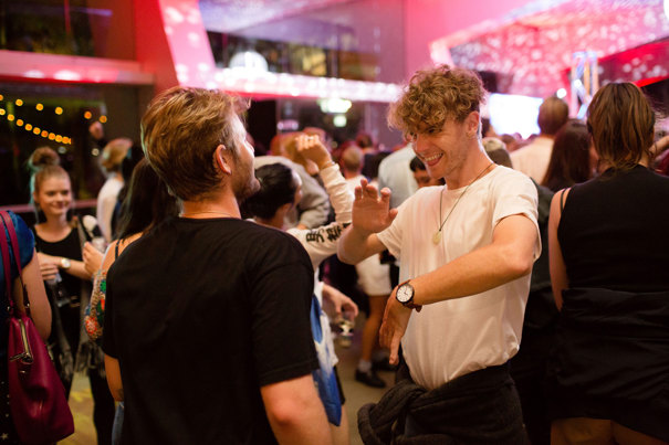 Two men dancing together at Melbourne Museum.