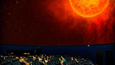 People watching a close-up of the sun on the planetarium screen at Scienceworks.
