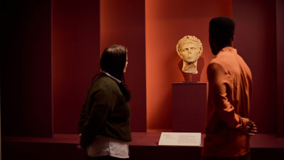 Visitors viewing a bust. 