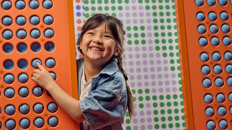 Smiling young child plays at Scienceworks