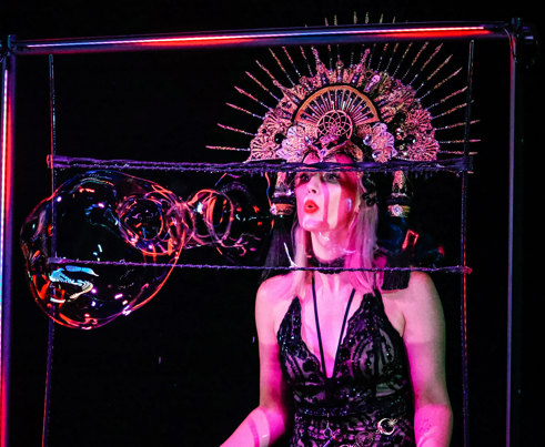 Becky Bubbles making bubbles during her Magic Noir performance.