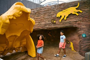Boy and a girl exploring a giant yellow skull in the Gandel Gondwana Garden
