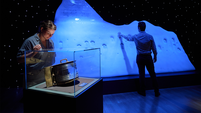 Two people exploring the Titanic exhibition