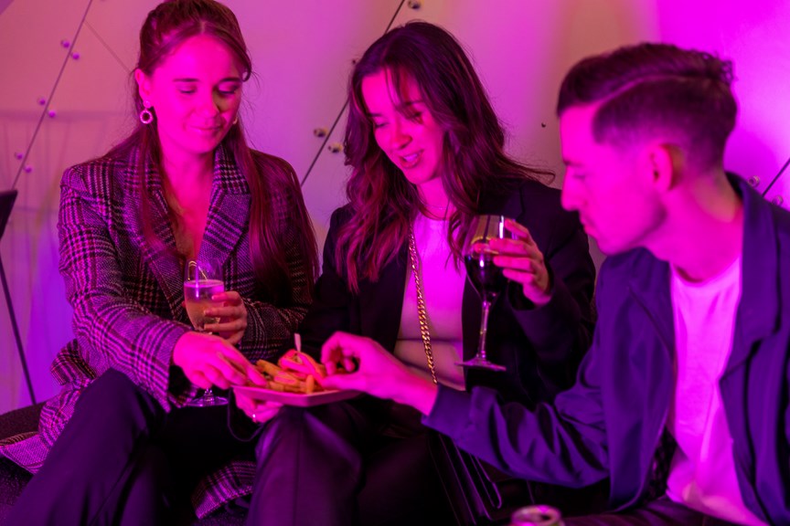 Three museum goers take a break and grab a bite and a drink.