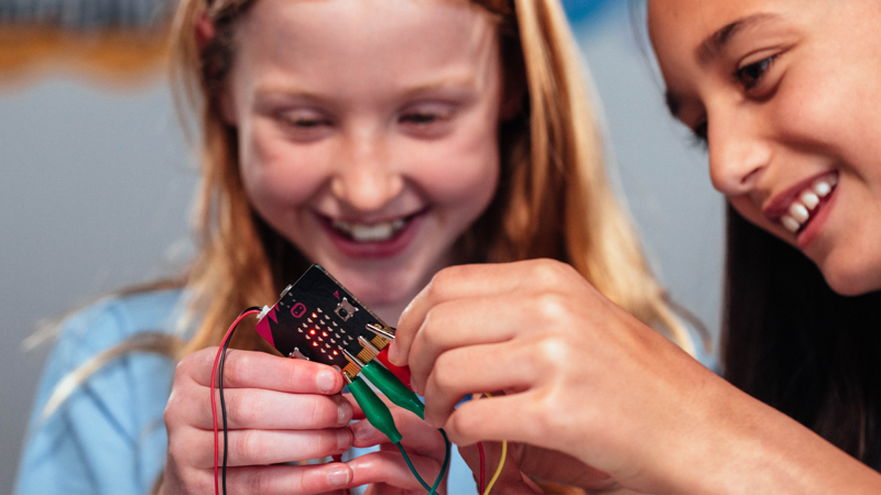  Two children playing with light and colours at Scienceworks.