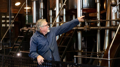 Engine Driver standing in front of a large steam engine.