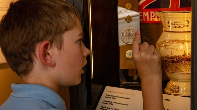  Primary school student looking at displays in Getting In exhibition in Immigration Museum.