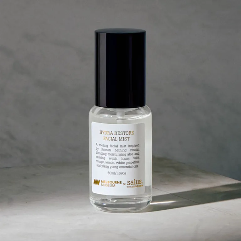 Small spray bottle that has clear liquid in it. It has text only label