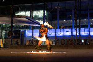 Logan Tapuala twirling fire outside Melbourne Museum.