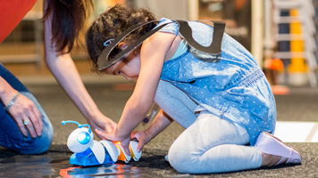 Child and parent playing with a Code-a-pillar in the Energy Lab during the Little Kids Day In program at Scienceworks, February 1st, 2021.