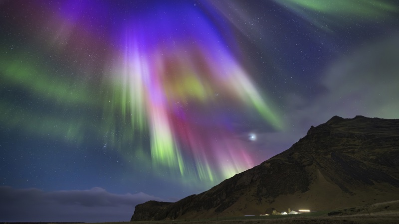 Multicolour auroral rays on a night of high activity near the famous Skógafoss waterfall.